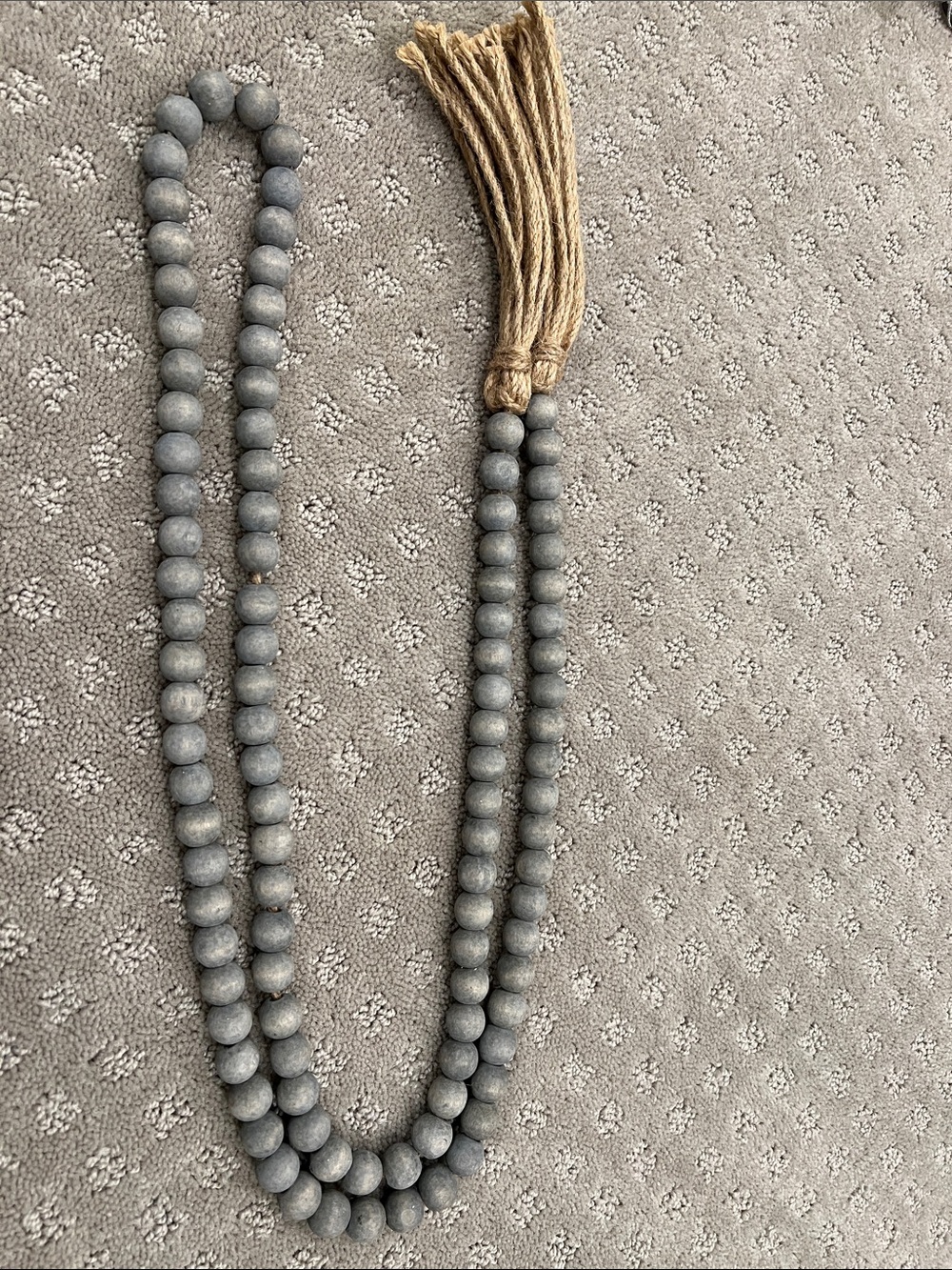 Gray bead strand with twisted twine on each end. Purchased from McGee and Co.